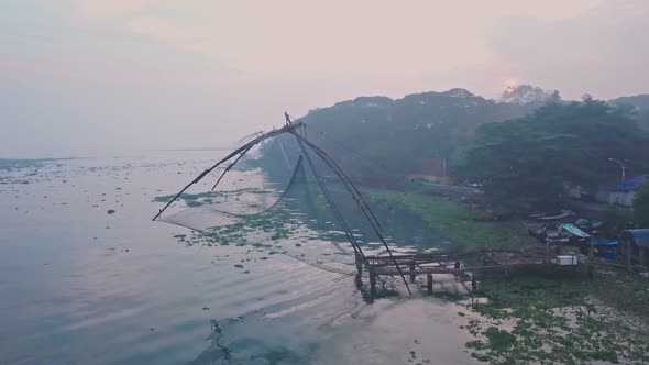 Sunrise at traditional Chinese fishing nets in Fort Kochi, India. Aerial drone view