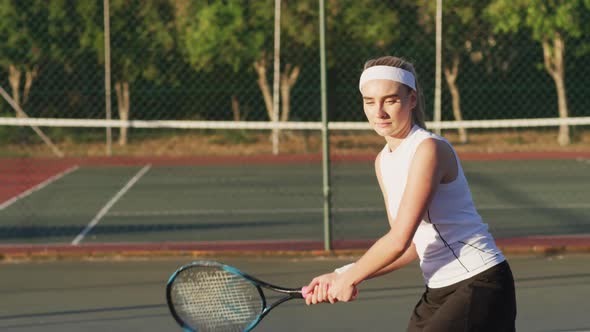 Video of happy caucasian female tennis player holding racket and hitting ball