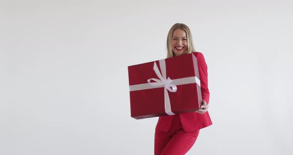 Pretty and Funny Woman Danses with a Big Box with a Present