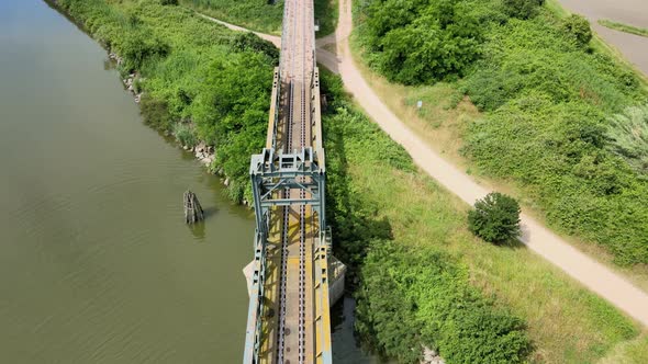 Flying above River and Metal Train Bridge