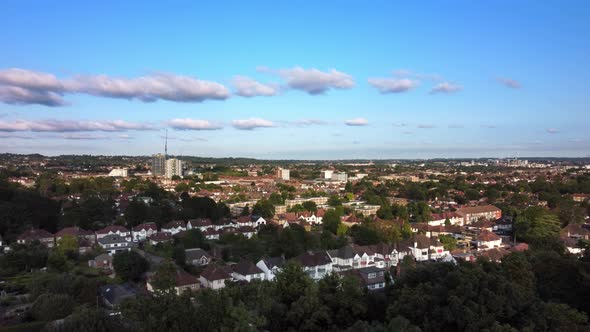 Aerial view of a North London urban town in summer sun. Static drone shot.