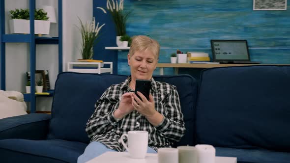 Happy Middle Aged Mature Woman Enjoying Using Mobile Apps Texting