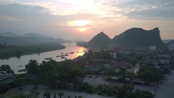 Amazing Sunset Above Tropical River Town and Tiny Boats