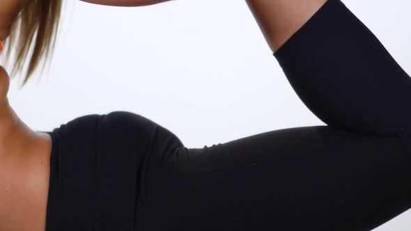 A Young Attractive Female Stretching And Doing A Yoga Pose On A White Background