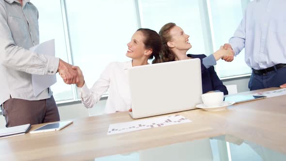 Business colleagues shaking hands with each other