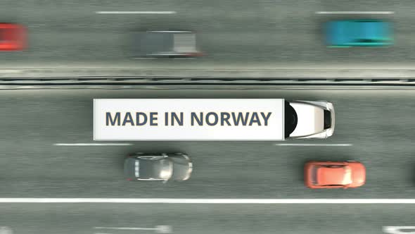 Trucks with MADE IN NORWAY Text Driving Along the Highway