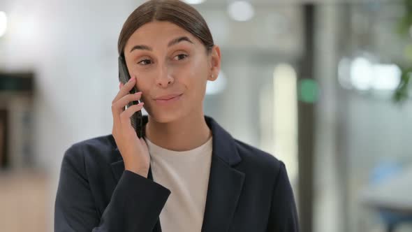 Portrait of Cheerful Businesswoman Talking on Smartphone