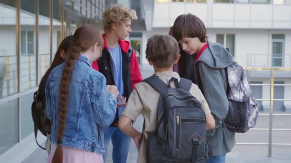 Portrait of Multiethnic Teenage Students Smile at Camera Outside School