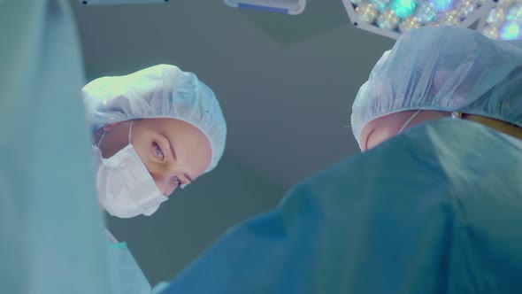 Medical Team Performing Surgical Operation in Bright Modern Operating Room