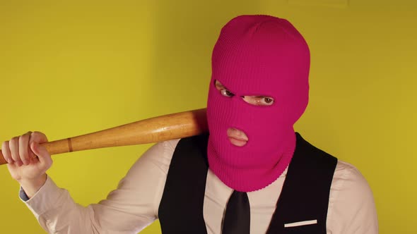 Man in Pink Balaclava with Baseball Bat