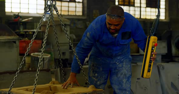 Worker using overhead crane in foundry workshop 4k