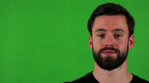 Young Handsome Bearded Man Talks To Camera - Green Screen - Studio - Closeup