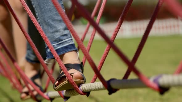 Kids walking on a rope bridge in the garden 4k