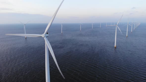 Offshore Windmill Park with Clouds and a Blue Sky Windmill Park in the Ocean Drone Aerial View with