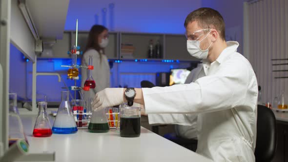 Young Scientist Mixing Colored Liquids