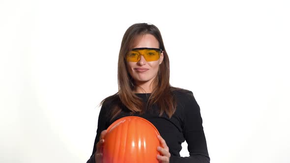 Female construction worker. Woman wearing protective helmet. Positive human emotions.