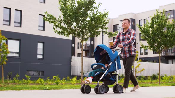 Father with Baby in Stroller and Coffee in City