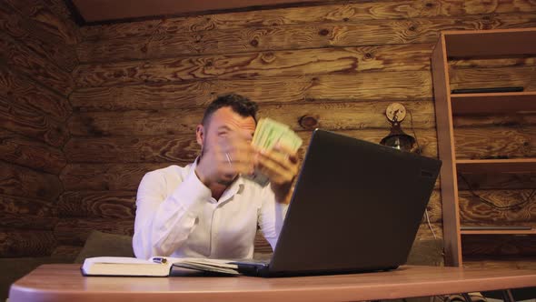 Happy Businessman Counts Dollars Banknotes and is Surprised at Income