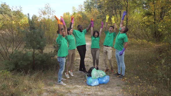 Happy Diverse Activists High Five After Trash Collection