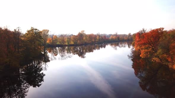 Aerial View. Flying over the beautiful autumn River. Aerial camera shot