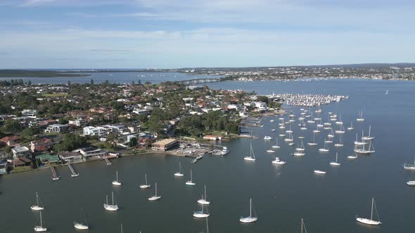 Aerial view of Marina in Kogarah Bay at San Souci. Ascending drone shot reveals the Captain Cook Bri