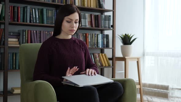 Casual Sitting Woman Closing Laptop and Leaving Sofa in Office