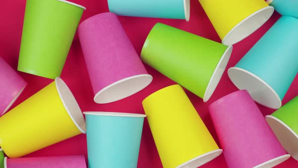 Flat Lay Multicolored Paper Cups. Background Red Color