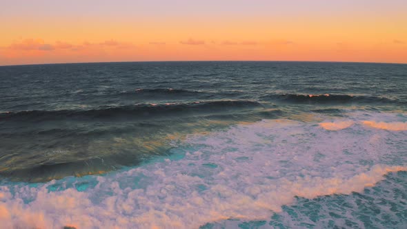 Powerful Wave Breaks Along the Shore at Beautiful Sunset Time