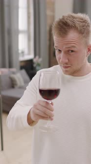 Vertical Portrait of Guy Drinking Red Wine and Dancing
