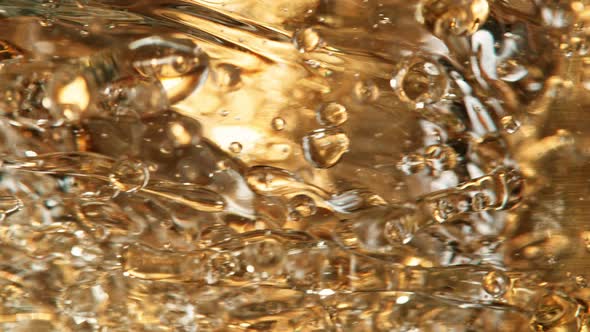 Super Slow Motion Detail Shot of Golden Oil Whirl at 1000Fps alt