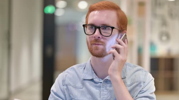 Portrait of Cheerful Casual Redhead Man Talking on Smartphone