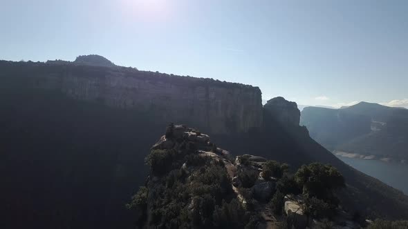 Aerial view of projecting cliff with trees and rocks in highlands