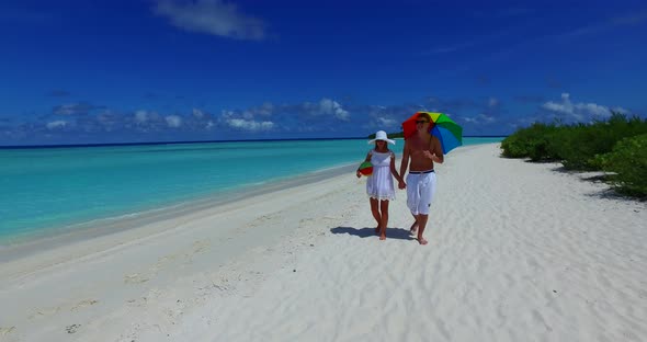 Young people on romantic honeymoon have fun on beach on paradise white sand 4K background