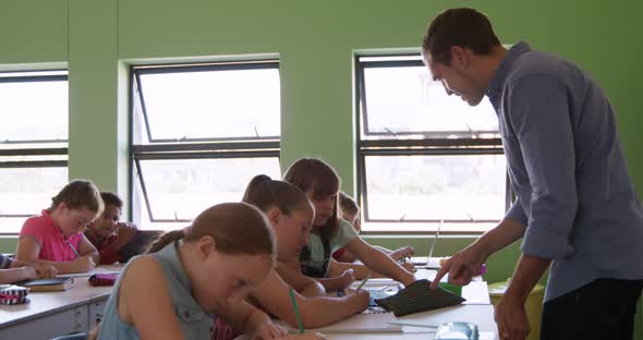 Male teacher teaching in the class