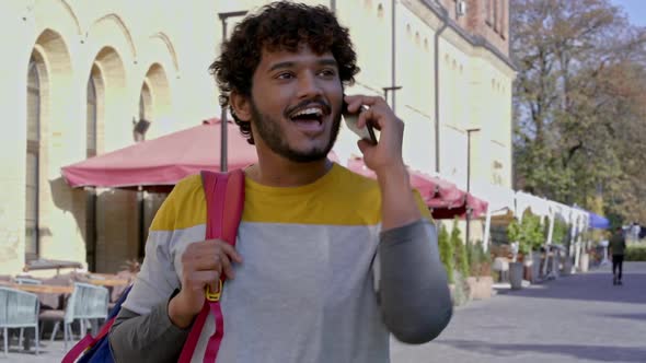 Smiling young man having call.