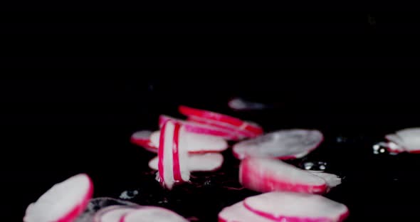 Slices of Fresh Radishes Fall Into the Water. 