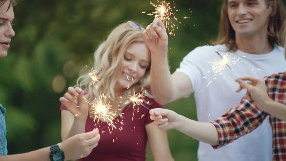 Happy Friends With Sparklers Having Fun Outdoors