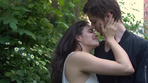 Couple kissing in a garden