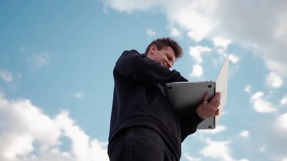 Guy Works at Laptop in City Park