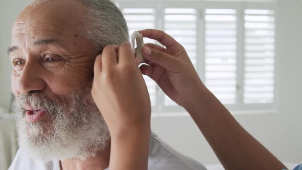 Mature man with hearing aid