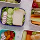 Shot of School Lunchboxes with Various Healthy Nutritious Meals on Stone Background - VideoHive Item for Sale