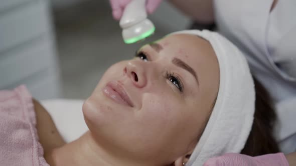 Young Woman Having Relaxing During Laser Cosmetology Procedure in the Salon