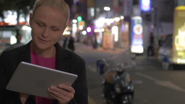 Woman with Pad in the City of Seoul at Night, South Korea