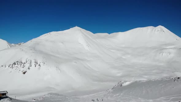 Unrecognizable Tourists Riding From Snowy Hill