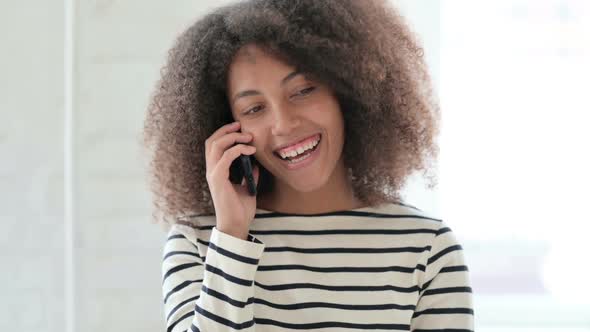 Cheerful African Woman Talking on Smartphone