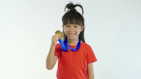 Little Girl Holding Golden Medal