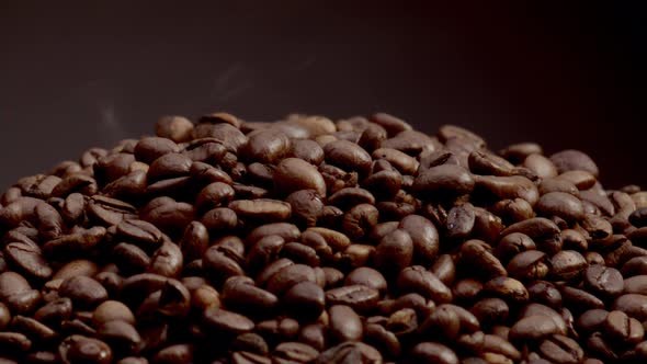 Closeup Heap Roasted Coffee Grains on Dark Backdrop