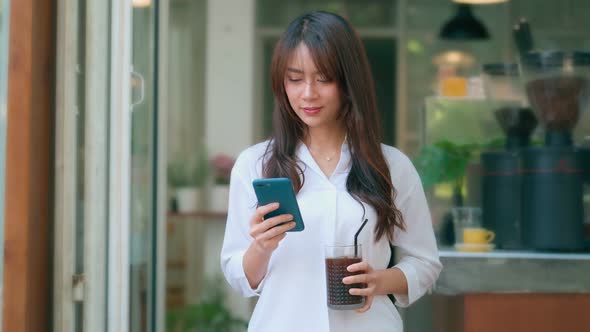 Beautiful Young Asian Woman Using Smartphone in Coffee Shop Happy Smiling