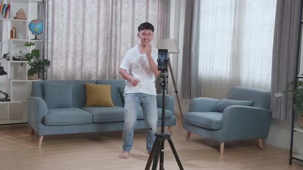 Asian Boy Dancing While Shooting Video Content For Social Networks With A Smartphone Camera