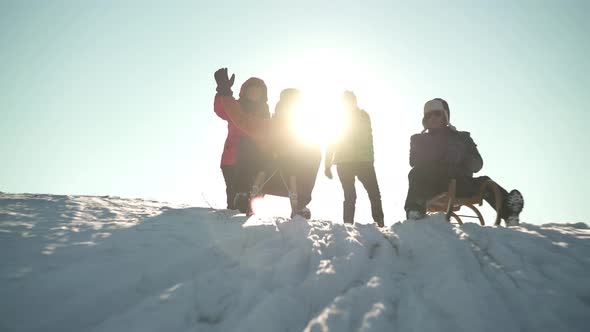 Two Happy Best Ager Couples Enjoying Cold Winter Day With Sled